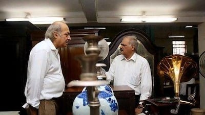Anwar Saleem, left, a senior partner of Russell Exchange speaks with his brother and business partner, Arshad Salim, during one of the exchange's auctions in Kolkata.