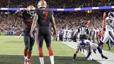 San Francisco 49ers running back Carlos Hyde, left, celebrates after running for a 10-yard touchdown with quarterback Colin Kaepernick during their NFL game against the Minnesota Vikings on Monday night. Marcio Jose Sanchez / AP / September 14, 2015