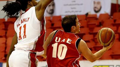 Omar Khaled, 10, of UAE, goes for a layup against Al Ahly Benghazi of Libya. Satish Kumar / The National