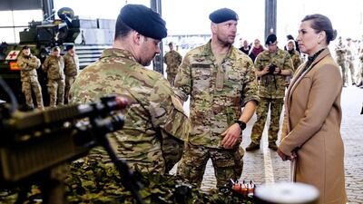 Danish Prime Minister Mette Frederiksen speaks with military officers during a visit to the island of Bornholm. EPA