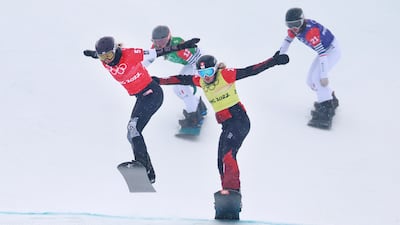Sina Siegenthaler, centre, and Lindsey Jacobellis, left, compete in the women's snowboard cross at the Zhangjiakou Genting Snow Park. EPA