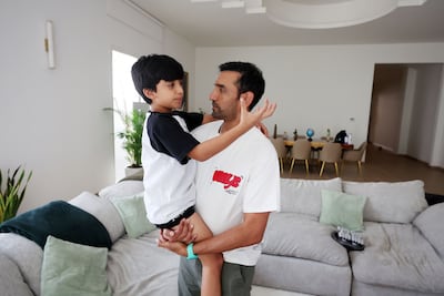 Uthappa and his son, Neale, at their home in Al Barsha. Chris Whiteoak / The National