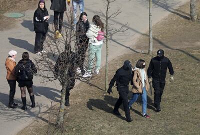 A woman is led away by Belarusian law enforcement officers, as opposition supporters gather for a rally against President Alexander Lukashenko. Reuters.