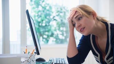 Frustrated Caucasian businesswoman using computer