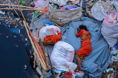Environmental devastation in Dhaka, where this woman sleeps on a polluted riverbank, is the inspiration for Saad Hossain's dystopian sci-fi. Amdad Hossain / Courtesy CIWEM Environmental Photographer of the Year