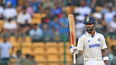 India's Virat Kohli celebrates after scoring a half-century (50 runs) during the third day of the first Test cricket match between India and New Zealand at the M. Chinnaswamy Stadium in Bengaluru on October 18, 2024. (Photo by IDREES MOHAMMED / AFP) / -- IMAGE RESTRICTED TO EDITORIAL USE - STRICTLY NO COMMERCIAL USE --