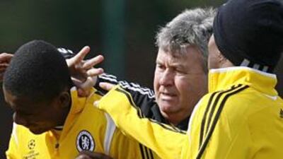 Hiddink, centre, flicks Salomon Kalou's ear as part of a punishment in Chelsea training yesterday.