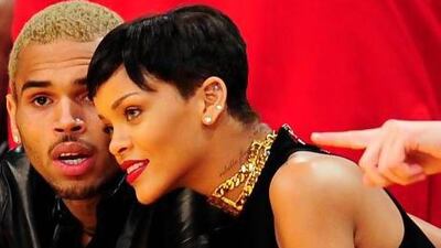 Rihanna, right, has confirmed that she and Chris Brown are back together. Brown is still on probation for assaulting her in 2009. Robyn Beck / AFP