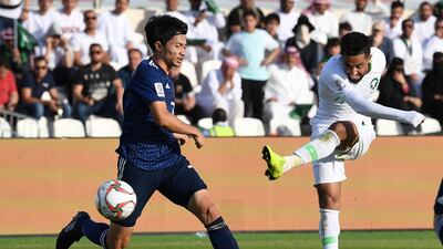 Shibasaki Gaku, left, of Japan in action against Hattan Babhir of Saudi Arabia. EPA