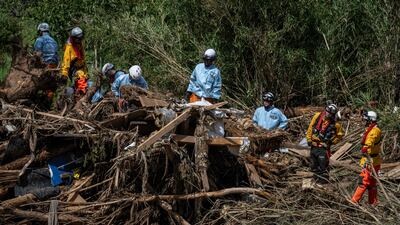 Rescuers search for missing people in debris from flooding along the Tsukada river in Wajima city, Japan. AFP