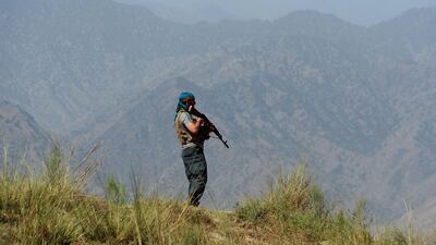 Afghan security forces keep watch near the site of a US air strike in Nangarhar province on August 12, 2017. US officials have denied Afghan claims that civilians were killed in the attack, which came two days after an air strike in neighbouring Kunar province killed several senior ISIL leaders. Noorullah Shirzada / AFP