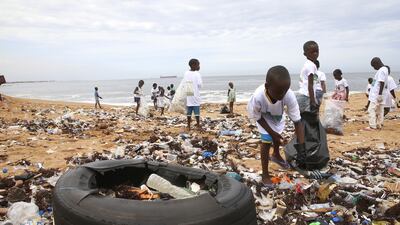 Members of an environmental NGO clean up plastic debris on Vridi beach, a popular tourist destination in the city of Abidjan, Ivory Coast, a day before World Environment Day. EPA