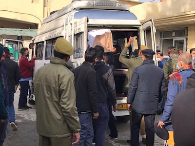 Policemen help to load the coffin of a stampede victim at a community health centre in Katra. AP Photo
