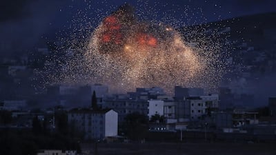 Thick smoke and flames from an airstrike by the U.S.-led coalition rise in Kobani, Syria, as seen from a hilltop on the outskirts of Suruc, at the Turkey-Syria border. Kobani, also known as Ayn Arab, and its surrounding areas, has been under assault by extremists of the Islamic State group since mid-September and is being defended by Kurdish fighters. Lefteris Pitarakis / AP Photo