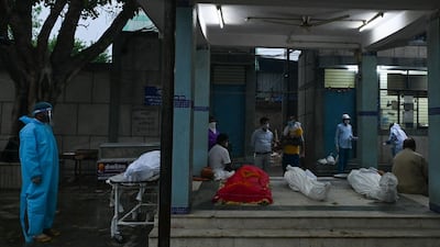 Covid-19 victims are seen outside a crematorium in New Delhi. AFP