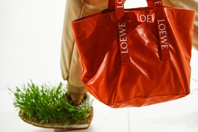 Grass-covered shoes and a branded shopper by British designer Jonathan William Anderson for Loewe. It has been confirmed that Anderson has exited the brand. EPA