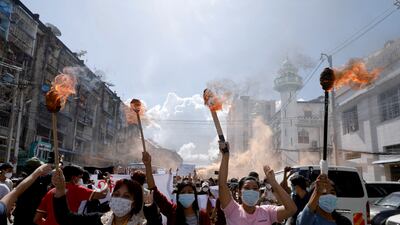 Women in Yangon take part in a protest against Myanmar's junta, one year after the military coup took place. Reuters
