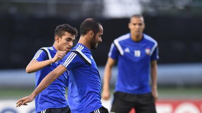 Striker Saeed Al Kathiri, front, contests with Walid Abbas.
