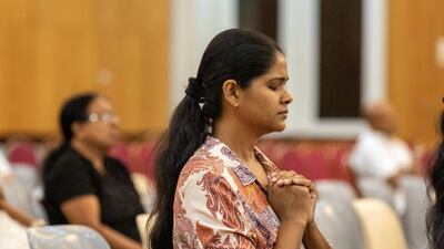 Worshippers gathered together as Sri Lankan priests led the service in Jebel Ali. Antonie Robertson / The National