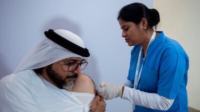 A media representative is vaccinated at the launch of the seasonal flu vaccination campaign at the Museum of the Future in Dubai. Ahmed Ramzan for The National