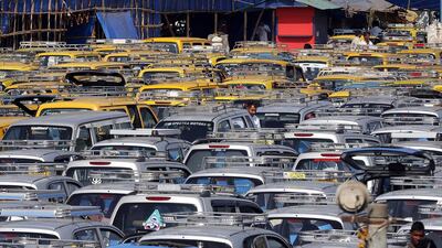 Traditional black-and-yellow licensed cabs and private cabs stand at a parking lot at the airport in Mumbai, India. Taxi-hailing smartphone app Uber is making a big push into Asia with the company starting operations in 18 cities in Asia and the South Pacific including Seoul, Shanghai, Bangkok, Hong Kong and five Indian cities in the last year. Rajanish Kakade / AP Photo