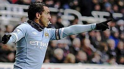 Tevez celebrates in his trademark style as if to silence his critics.