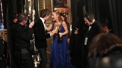 Eddie Redmayne, left, congratulates Brie Larson backstage after she accepts the award for best actress in a leading role for Room. Matt Sayles / Invision / AP
