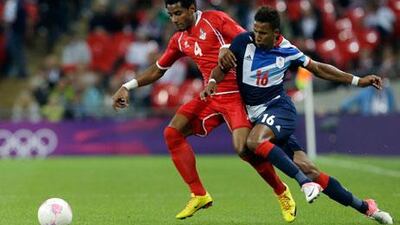 The UAE's Mohamed Ahmad holds off Team GB's Scott Sinclair during their London 2012 clash
