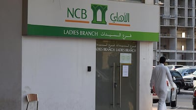 S&P lowered its long-term counterparty credit ratings on National Commercial Bank, among other Saudi banks. Fayez Nureldine / AFP