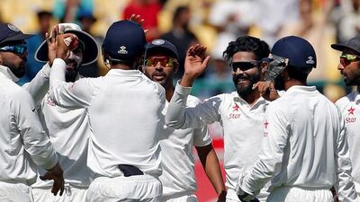 Ravindra Jadeja, second right, celebrates the wicket of Shaun Marsh. Adnan Abidi / Reuters