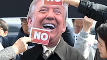 A South Korean protester wears a mask of Donald Trump during a protest in Seoul against the US President's request to send warships to the Strait of Hormuz. AFP