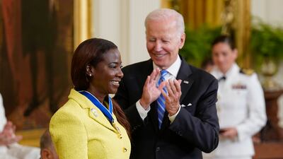 Mr Biden awards nurse Sandra Lindsay, the first person in the US to have the Covid-19 shot. AP