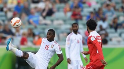 UAE winger Ismail Al Hammadi, left, tries to control the ball in front of Bahrain full-back Rashed Al Hooti.