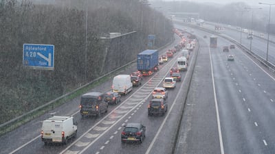 Motorists driving through snowfall on the M20 near Maidstone. PA