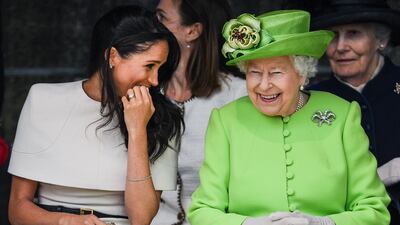Queen Elizabeth sits and laughs with Meghan during a ceremony to open the new Mersey Gateway Bridge in Cheshire, in June 2018. Getty Images