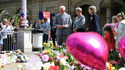 The king views tributes outside the Town Hall. PA