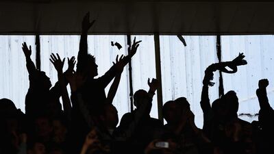 Burnley fans celebrate during their club's Premier League draw against Leicester City on Saturday in Leicester. Laurence Griffiths / Getty Images