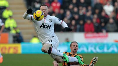 Hull City's David Meyler, right, vies with Manchester United's Wayne Rooney during their English Premier League match at the KC Stadium in Hull on Thursday. Lindsey Parnaby / AFP