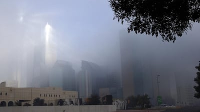Sun rays pass through the thick fog on Hamdan street in Abu Dhabi. Ravindranath K / The National