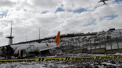 Pegasus Airlines technicians work at the wreckage of Pegasus Airlines Boeing 737-86J plane, after it overran the runway during landing and crashed, at Sabiha Gokcen airport, in Istanbul, Turkey. REUTERS