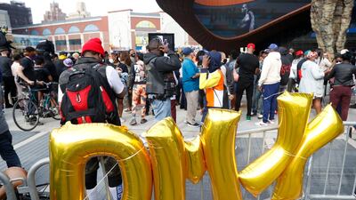 People gather outside the Barclays Centre where a private memorial for late US rapper DMX was being held, in Brooklyn, New York. EPA