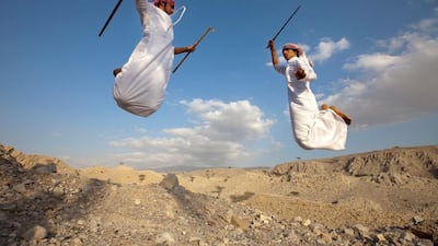 Ras Al Khaimah - Brothers Mohammed Al Shehhi, left, and Abdulla Al Shehhi, perform the the The Mzafin (confrontation) during the sword dance at Khatt town. Jaime Puebla / The National