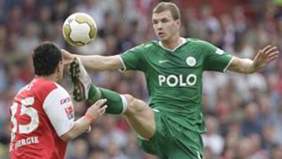 Wolfsburg's Edin Dzeko, above right battling with Energie Cottbus' Cagdas Atan, has had an impressive season in the Bundesliga and has helped put his side top of the table.