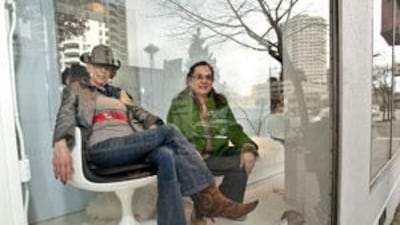 Mari Franke, left, on an Eero Aarnio chair, with her daughter, Rae McCullough, in the window of their shop in Seattle.
