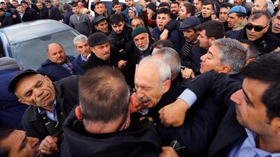 Kemal Kilicdaroglu, the leader of the Republican People's Party, is attacked at a village outside of Ankara on Sunday during the funeral of a Turkish soldier who was killed during clashes with Kurdish rebels. AP