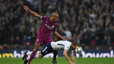 Tottenham striker Harry Kane is challenged by Vincent Kompany. Shaun Botterill / Getty Images