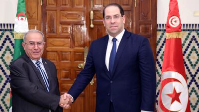 Tunisian Prime Minister Youssef Chahed, right, shakes hands with Algeria's Vice Prime Minister Ramtane Lamamra, in Carthage. AP Photo