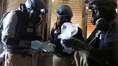 A UN chemical weapons expert with a bag containing chemical elements. Reuters