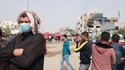 Relatives of workers stand near the site of a textile factory after a fire broke out in Obour industrial district, outskirts of Cairo, Egypt. At least 20 people died and 24 were injured after a fire broke out in a textile factory northeast of Cairo, local authorities reported after controlling the fire. EPA