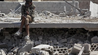 A man sits among the debris near the town of Saraqeb in Syria's rebel-held northwestern province of Idlib. Amer Alhamwe / AFP